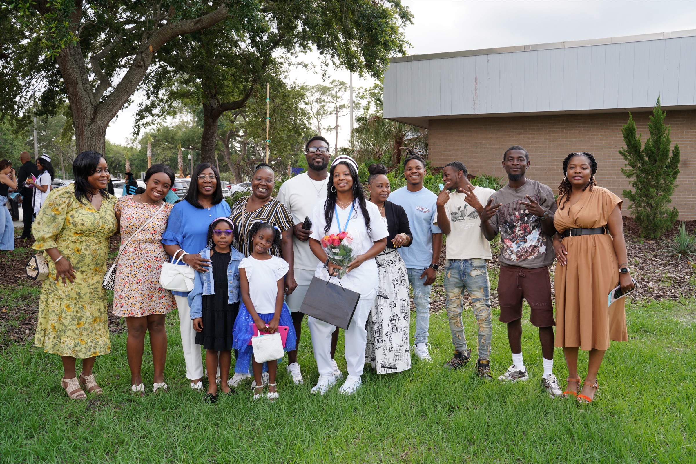 Big family gathered on the lawn celebrating their new nurse